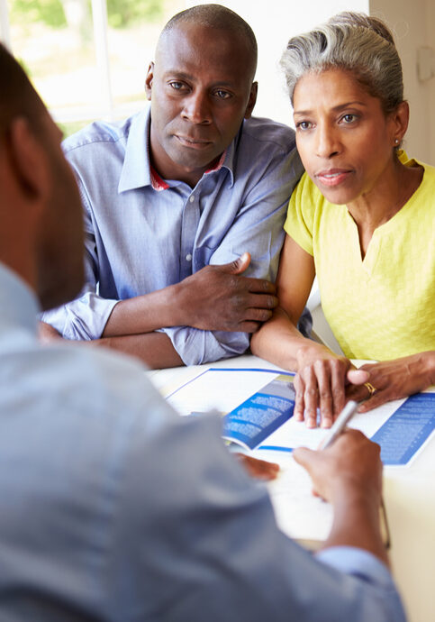 Mature Black Couple Meeting With Mixed race Financial Advisor At Home